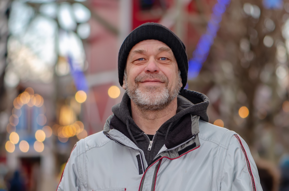 Street portrait of an elderly bearded man 50-55 years old.